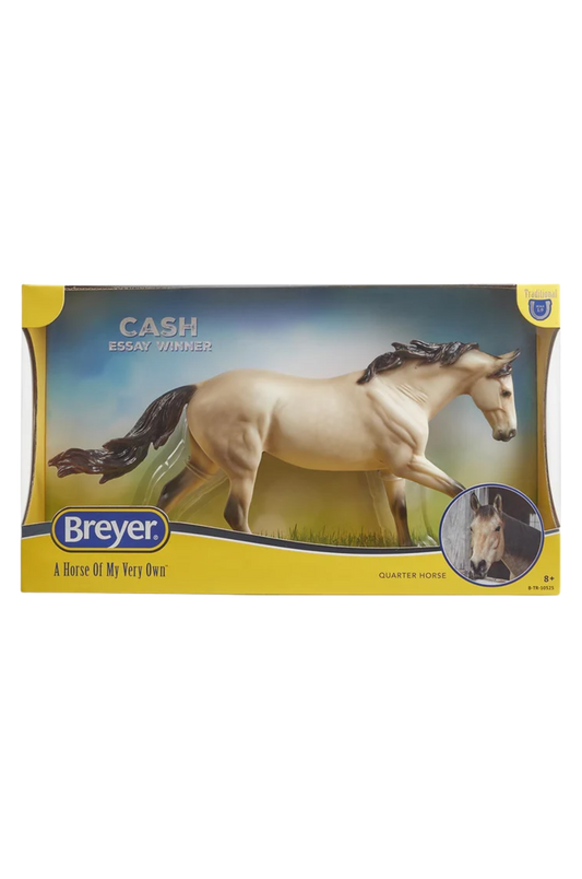 Breyer model horse in packaging with a white horse on a grassy field