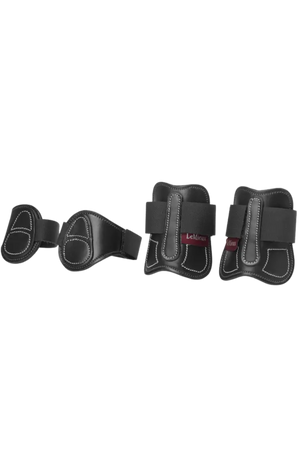 Set of four black protective pads on a white background